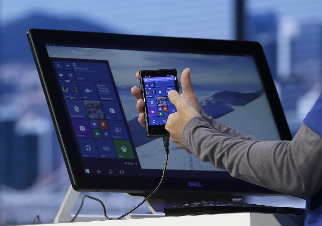 alt="Joe Belfiore, Microsoft Corporate Vice President of Operating Systems Group, demonstrates Continuum for phones at the Microsoft Build conference"