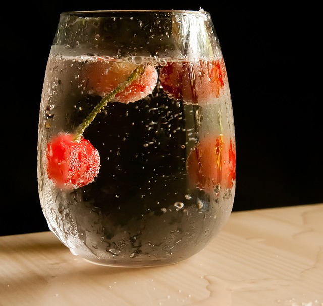 "glass of water with cherries"