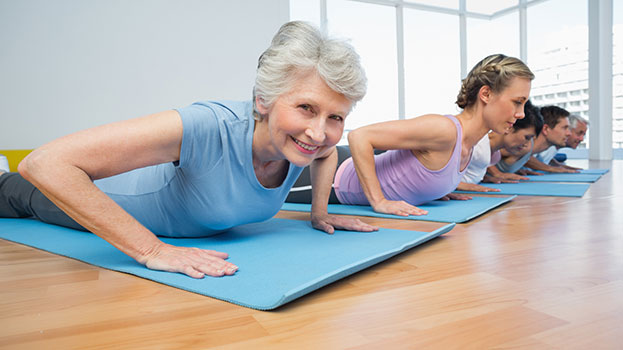"elderly people practicing yoga"