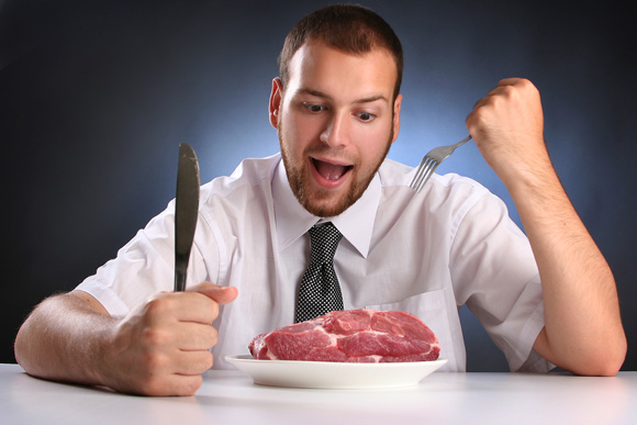 alt="Man eating meat"