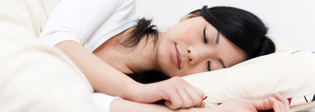 alt="Asian Woman Sleeps Peacefully"
