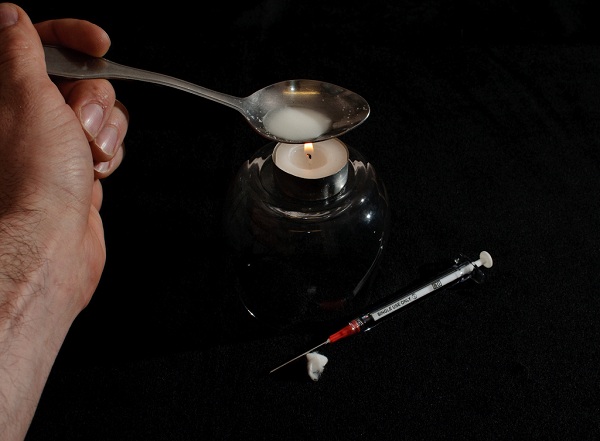 A heroin addict preparing his drugs