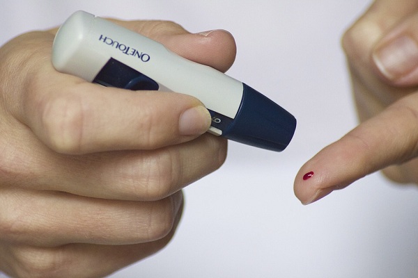 A woman testing her blood sugar level