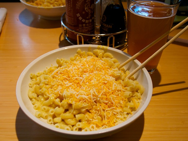 Mac and cheese on a restaurant table eaten with chopsticks
