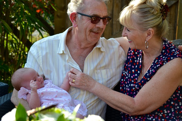 Older couple holding a baby