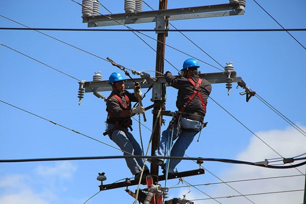 Two line workers working