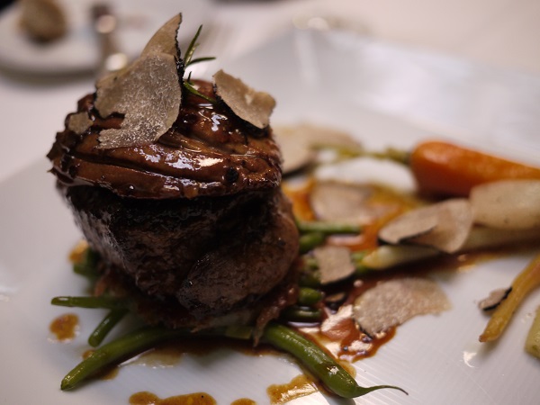 black truffles on plate with vegetables
