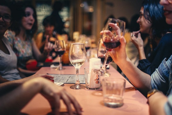 People sitting at a table and drinking wine