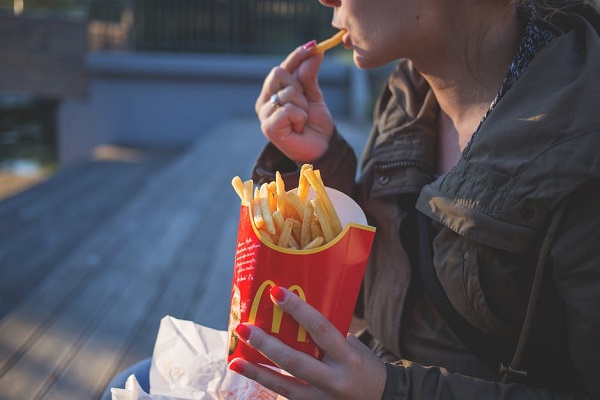 Woman eating French fries